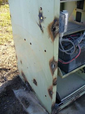 Close-up of damage to a power-supply cabinet
